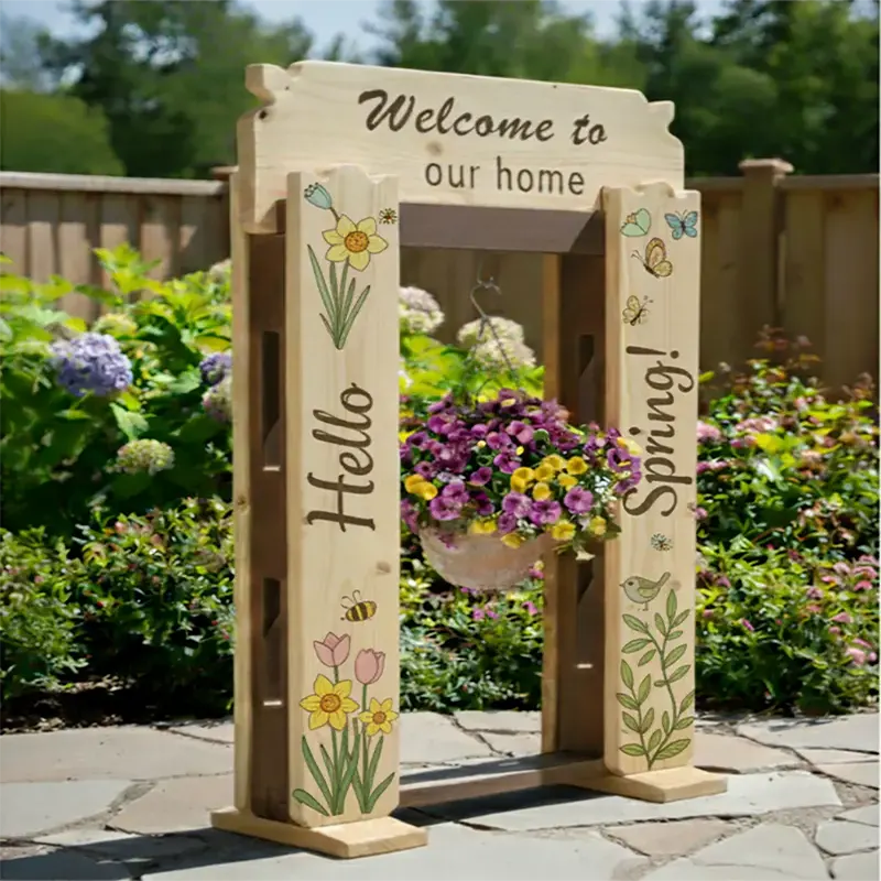 StandCraft Canada display stand decorated with a 'Hello Spring!' theme, featuring spring flower and butterfly illustrations, a 'Welcome' sign, and a hanging flower basket in a garden.
